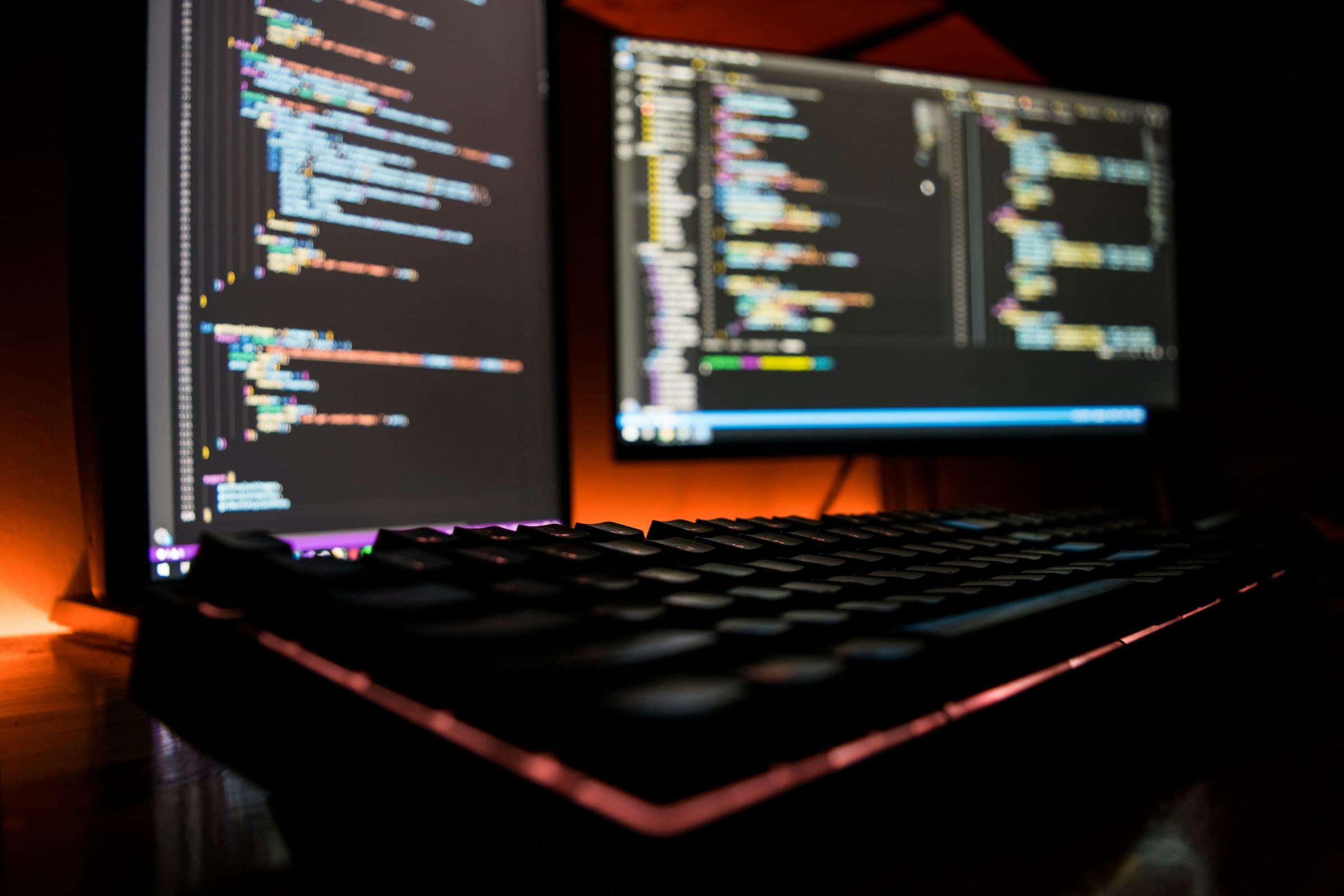 Developer workspace with code on two monitors